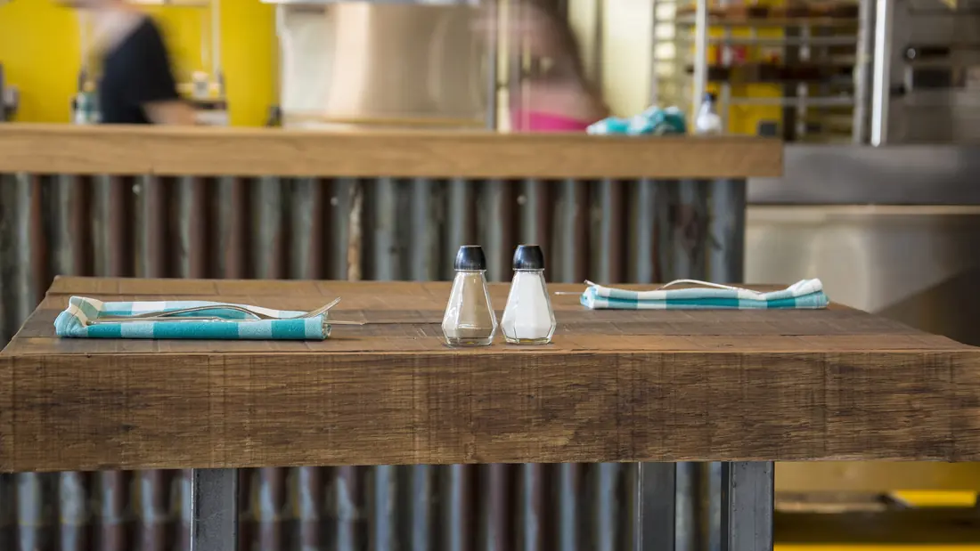 A salt shaker on a dining table